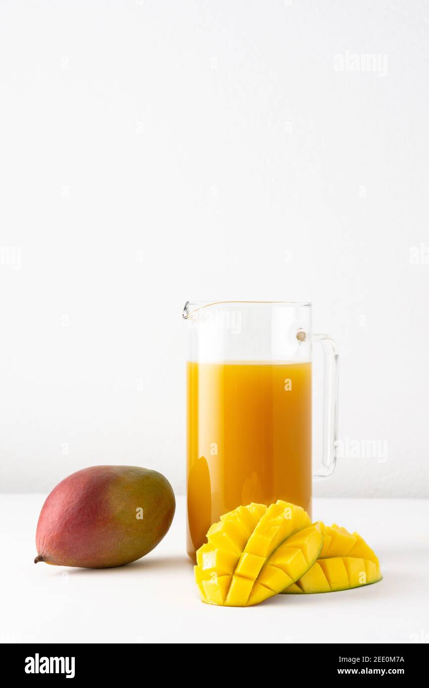 Jug of Mango and Orange Juice with Two Full Glasses Stock Photo - Alamy