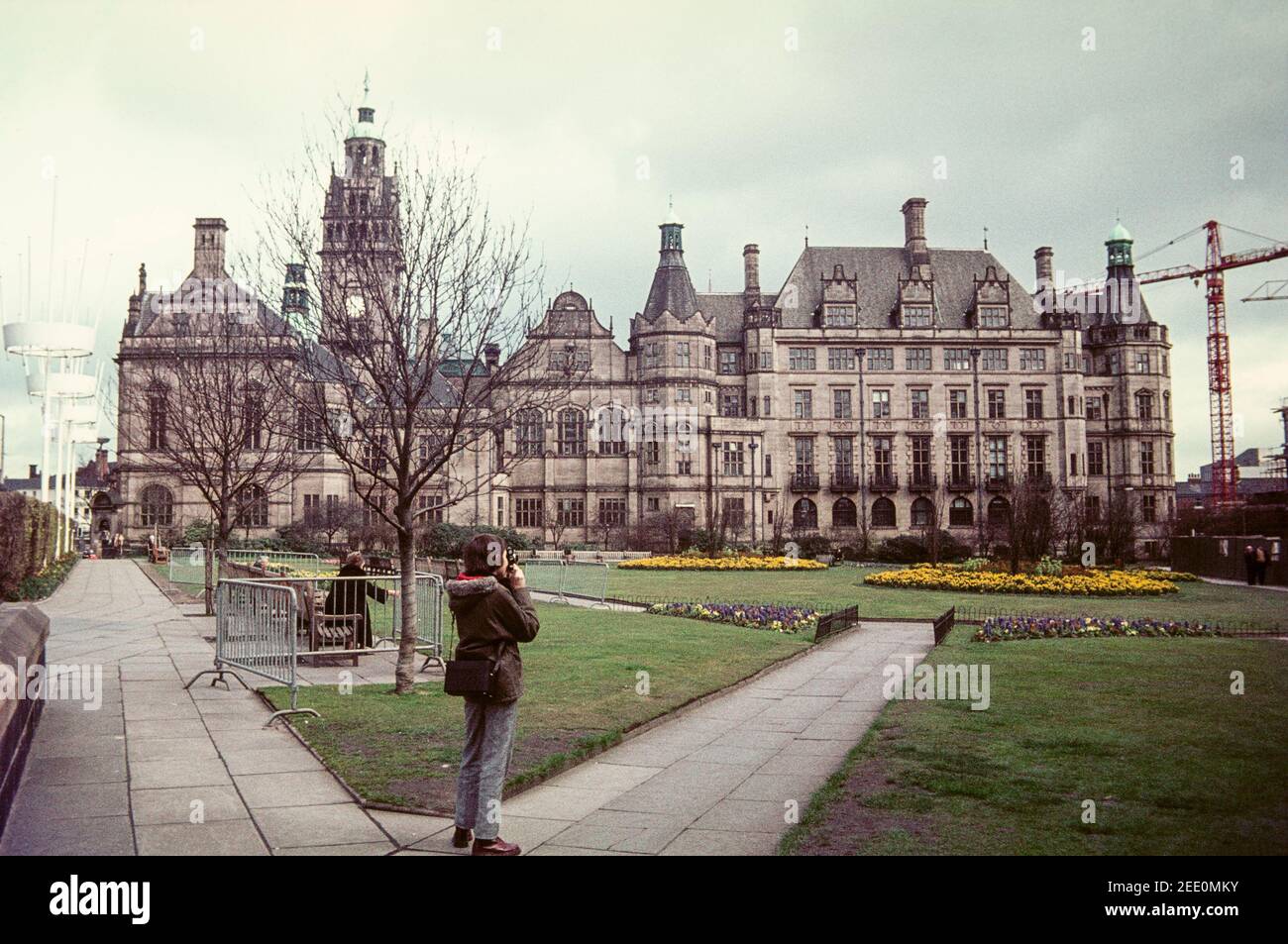 1975 Shefffield Young man taking photograph of The Egg Box construction  from The Peace Gardens in Sheffield, England. The Gardens front onto  Sheffield's gothic town hall. The Gardens were laid out in