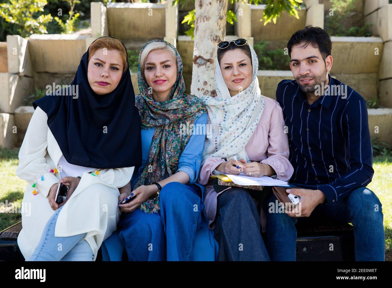Young Iranians posing in modern Islamic clothes, women wearing headscarves in the city Tehran, Iran Stock Photo