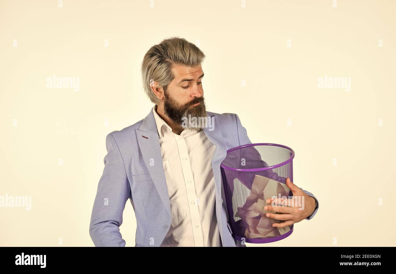 Destroy evidence. Insure important documents. Recover files after deletion. Businessman hold trash can. Man look for lost document in paper bin. Office worker digging in garbage bin. Recover document. Stock Photo
