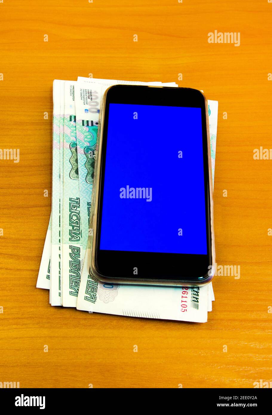 Russian Rubles and Mobile Phone on the Wooden Table closeup Stock Photo