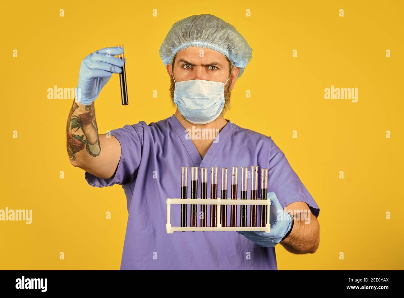 Critical number or density of susceptible hosts. Man in medical lab inspecting samples biological material. Epidemic disease. Virus concept. Epidemic infection. Genetic analysis. Epidemic threshold. Stock Photo