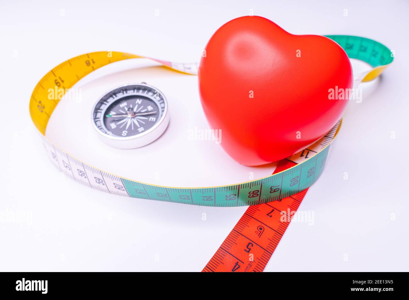 Top view red heart shape and white measurement tape on white background ...