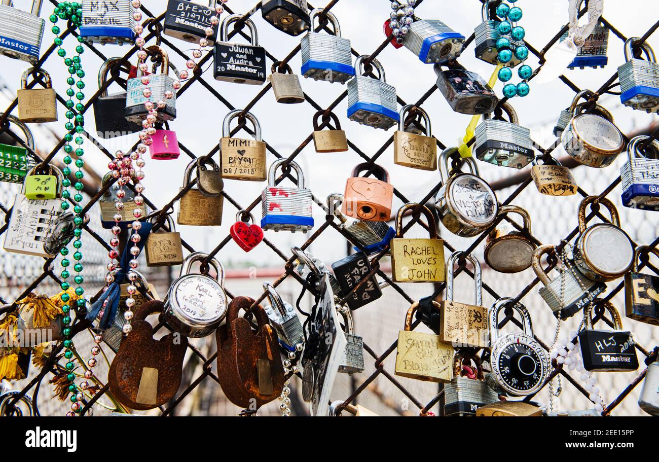 Padlocks hanging from a chain link fence in New Orleans, Louisiana Stock Photo
