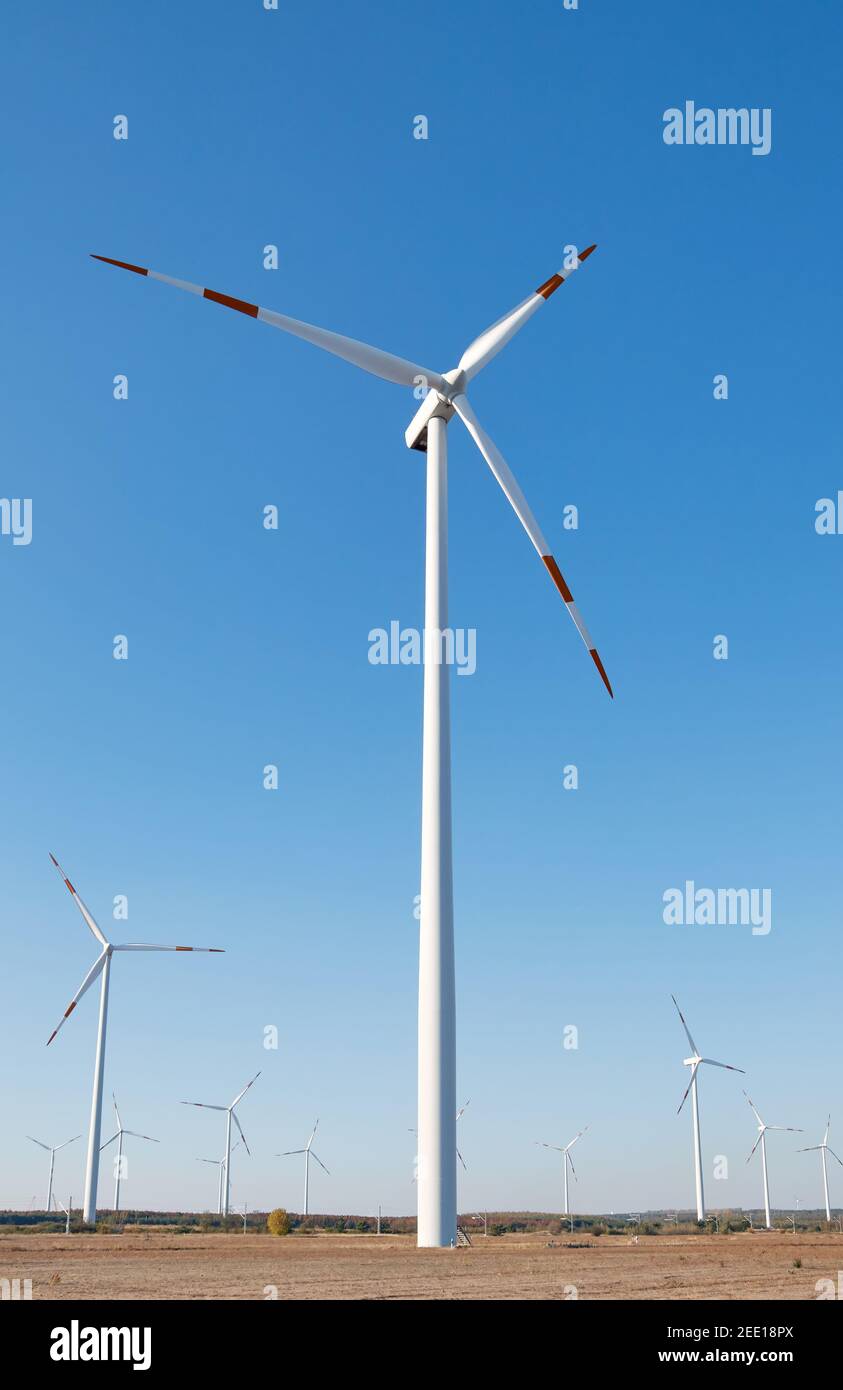 Picture of a wind turbine farm against the blue sky. Stock Photo