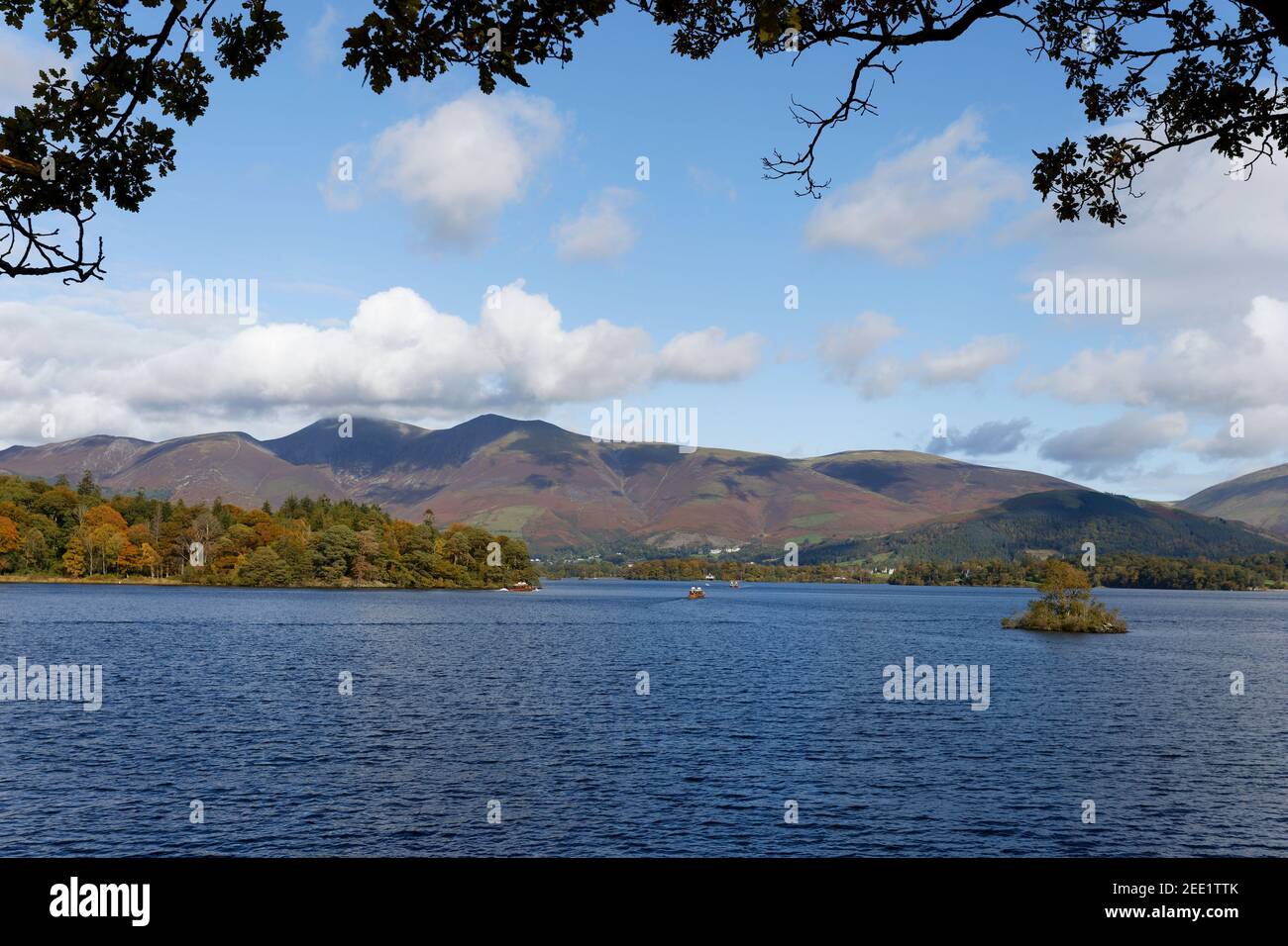 Distant view of Skiddaw and local ferry on Derwent Water Lake District Cumbria Stock Photo
