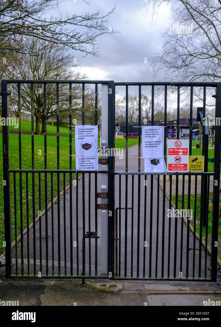 School gates with face mask and covid19 social distancing signs outside Sunnyfields Primary School, Hendon, London Borough of Barnet. UK Stock Photo