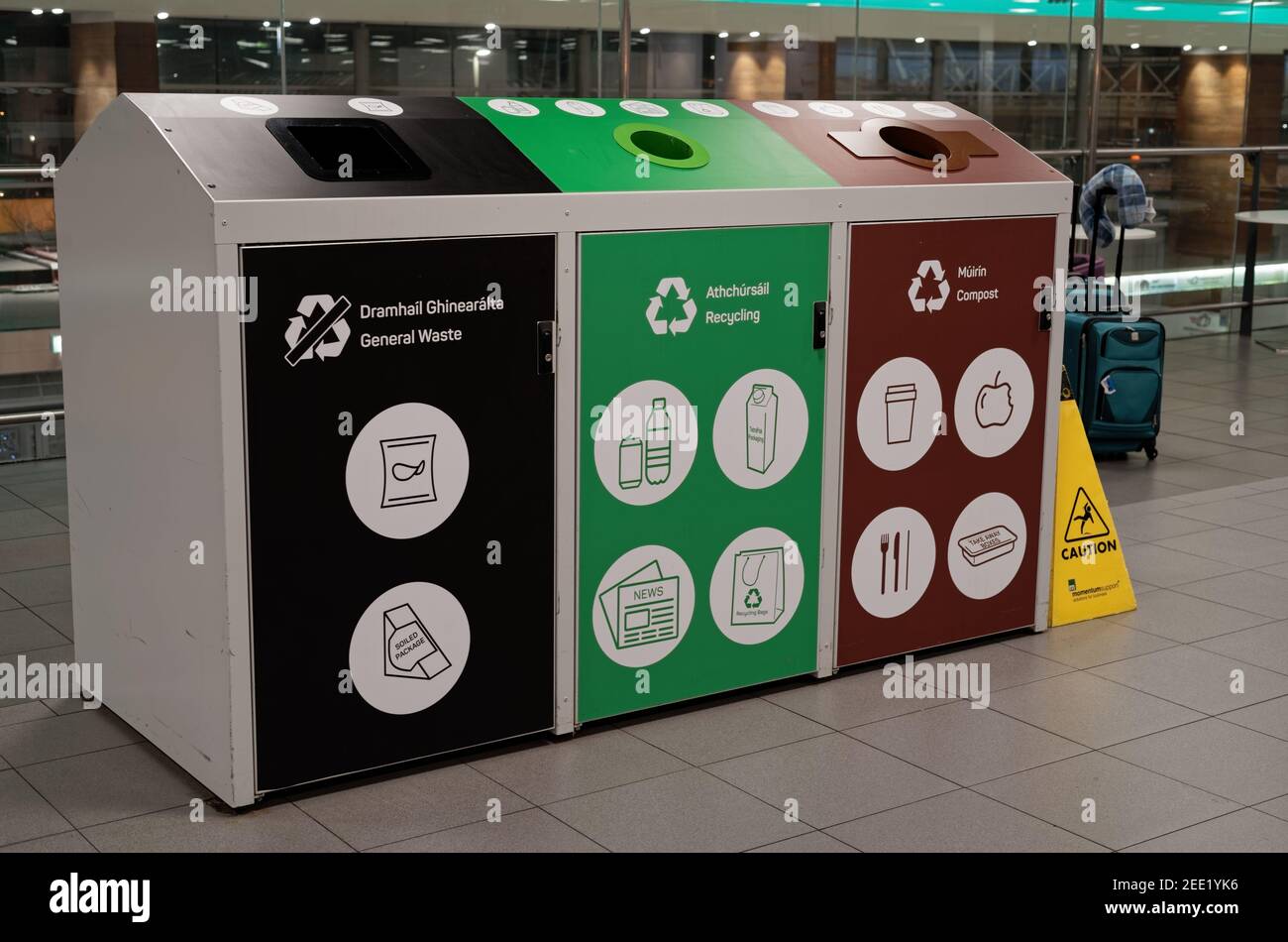 DUBLIN, IRELAND - Jan 11, 2020: Row of colorful bins for waste segregation in the Food Court at Terminal 1, in Dublin Airport. Text with instructions Stock Photo