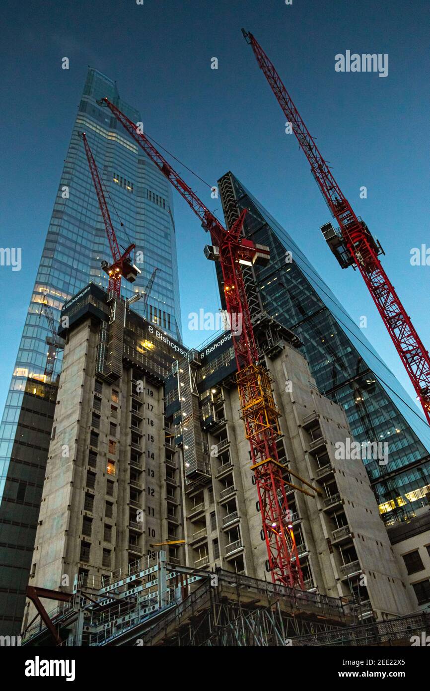 Twilight view looking up at construction work of 8 Bishopsgate with skyscraper 22 bishopsgate towering into the sky - Stock Image