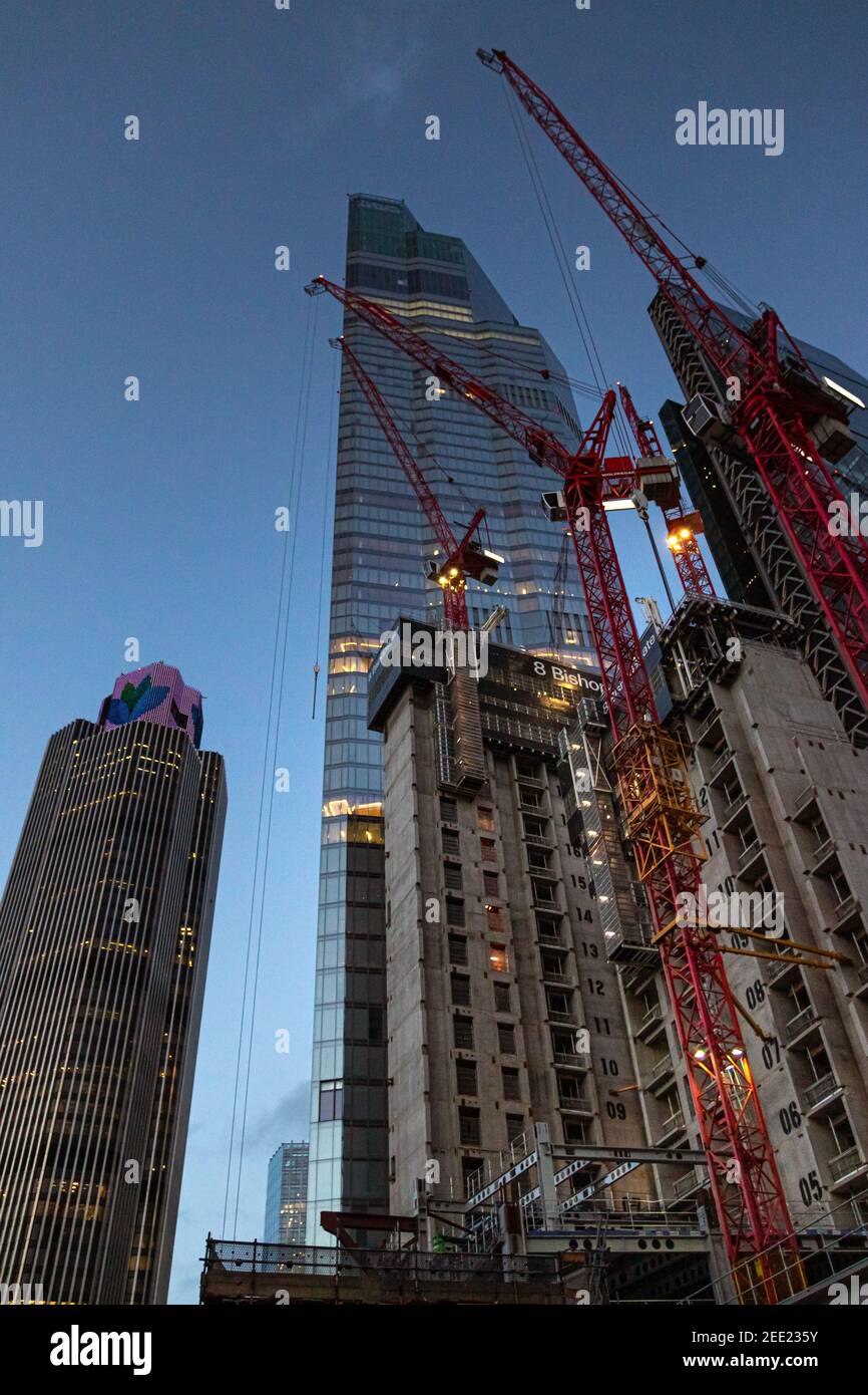 Twilight view looking up at construction work of 8 Bishopsgate with tower 42 and skyscraper 22 bishopsgate towering into the sky - Stock Image