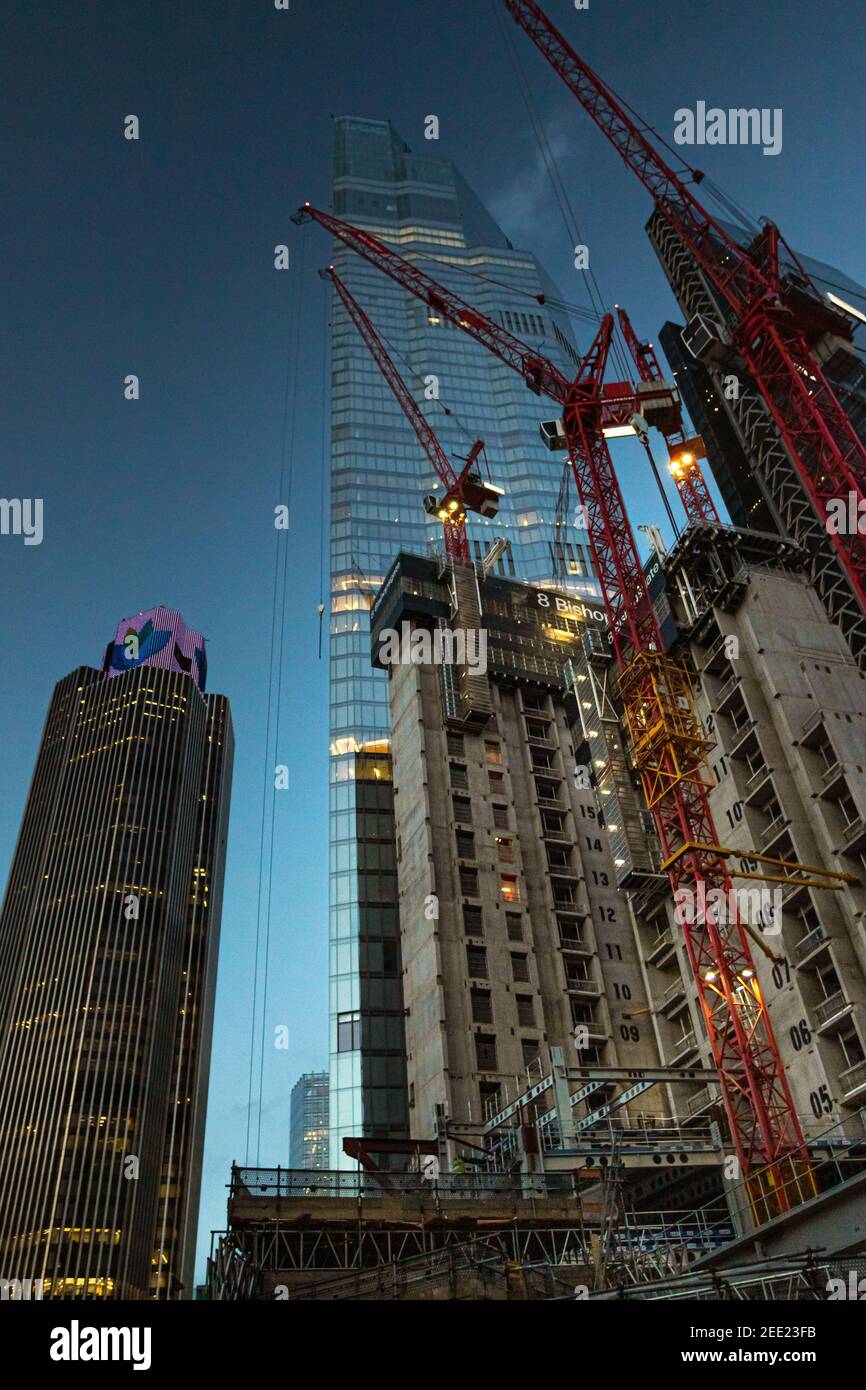 Twilight view looking up at construction work of 8 Bishopsgate with tower 42 and skyscraper 22 bishopsgate towering into the sky - Stock Image