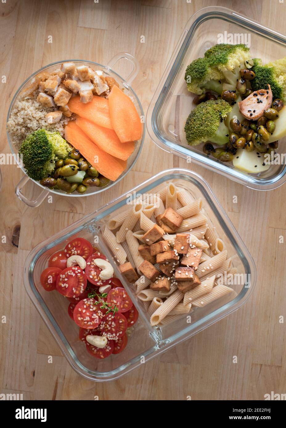 Batch cooking scene composed by three glass containers full of healthy