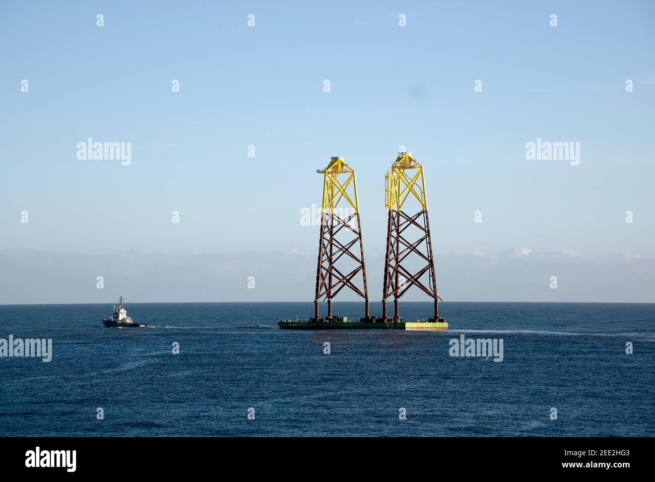 Legs for wind turbine being towed out of the River Tyne in Tyne and Wear, England, United Kingdom, UK, Stock Photo