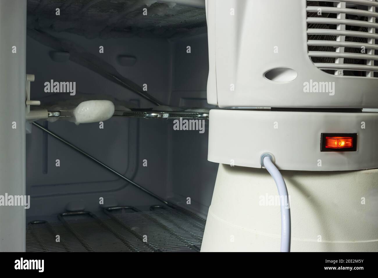 Defrosting freezer with a heater Stock Photo