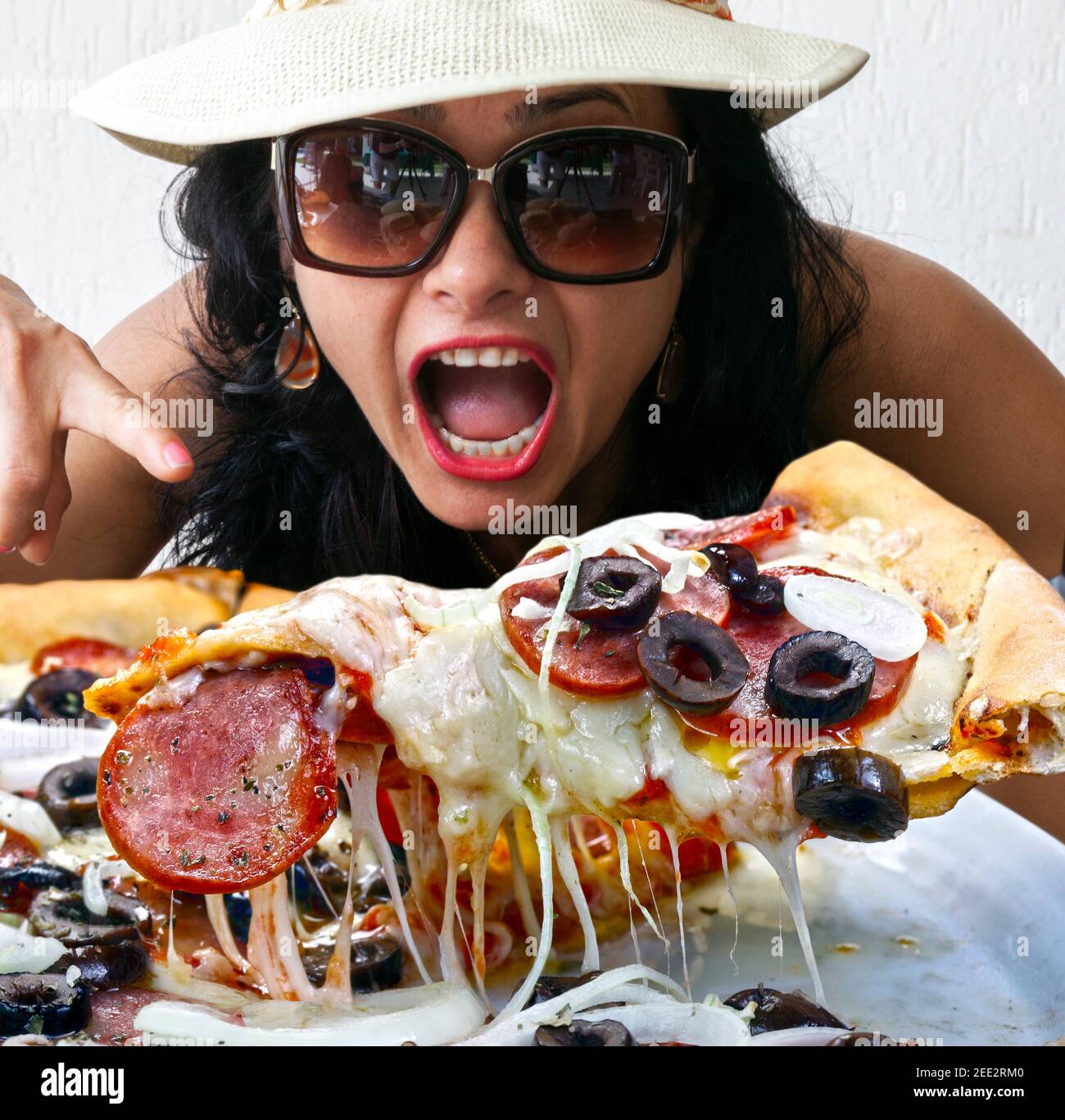 Woman Eating Pepperoni Pizza Stock Photo
