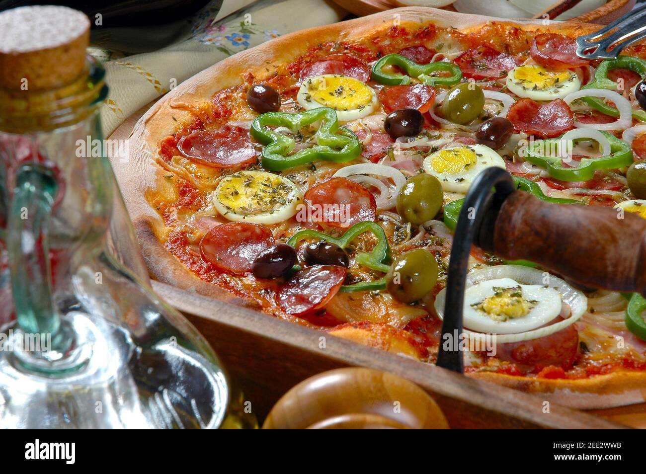 Portuguese Pizza, onion, peppers, pepperoni, egg, olive Stock Photo Alamy