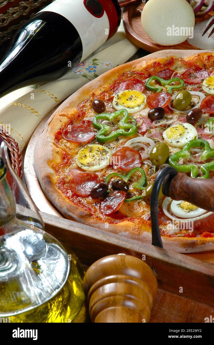 Portuguese Pizza, onion, peppers, pepperoni, egg, olive Stock Photo Alamy