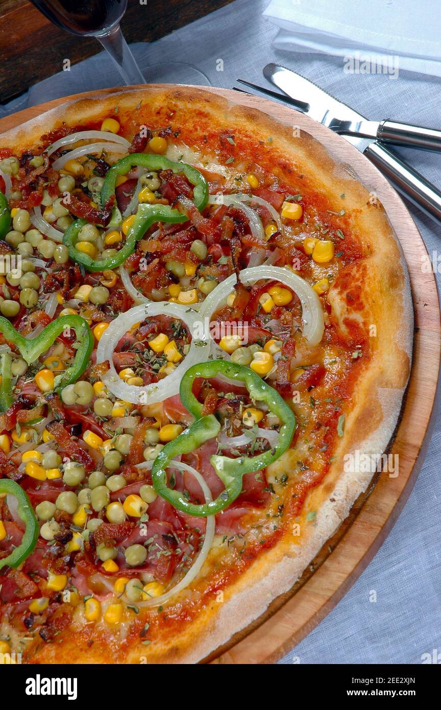 Pizza with corn, bacon, chili, onion, pea Stock Photo Alamy