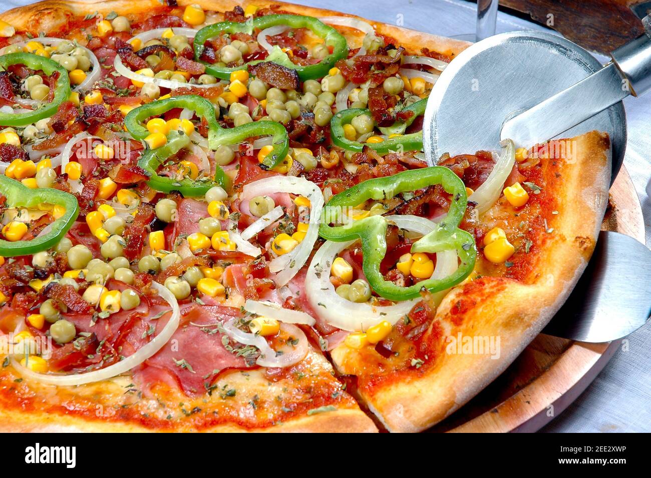 Pizza with corn, bacon, chili, onion, pea Stock Photo Alamy