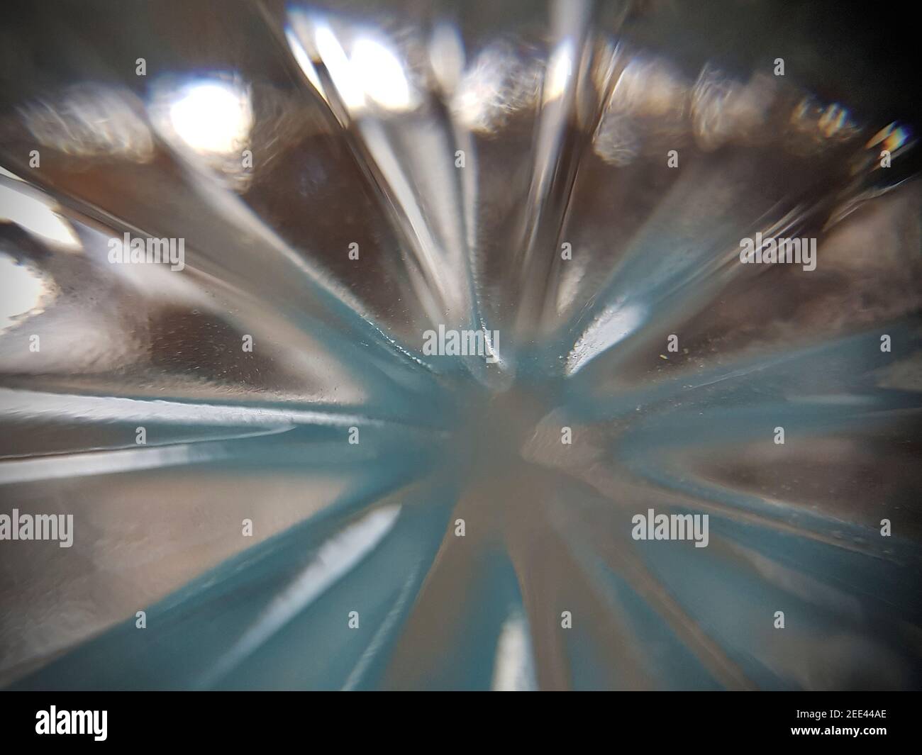 Starr burst of light with a blue tinge. This is light from the bottom of a glass Stock Photo