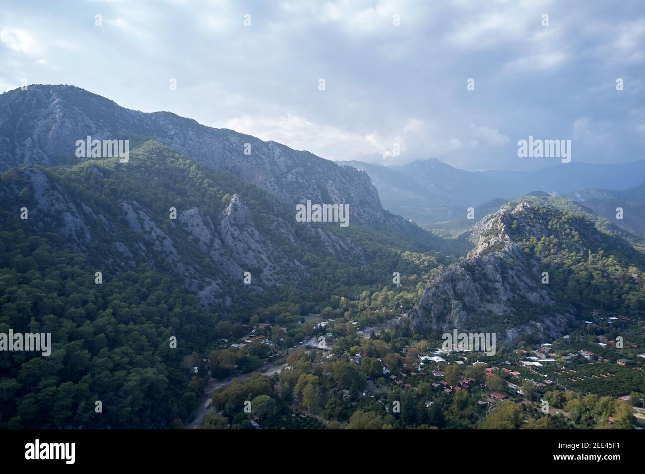 Alpine village in the valley surrounded by mountains Stock Photo - Alamy