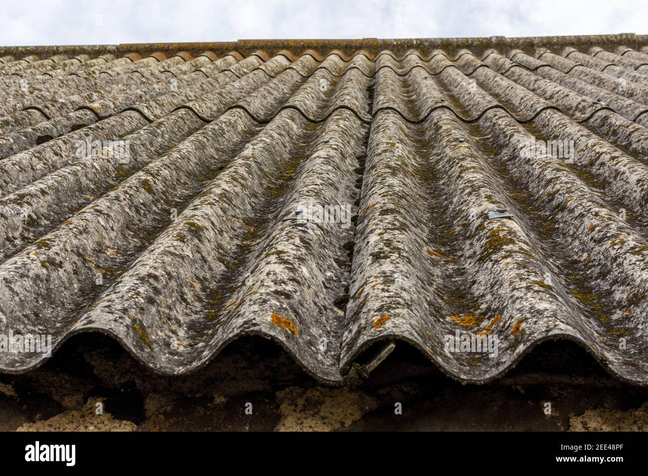 Closeup shot of roof tiles covered in rust under the the cloudy sky Stock Photo