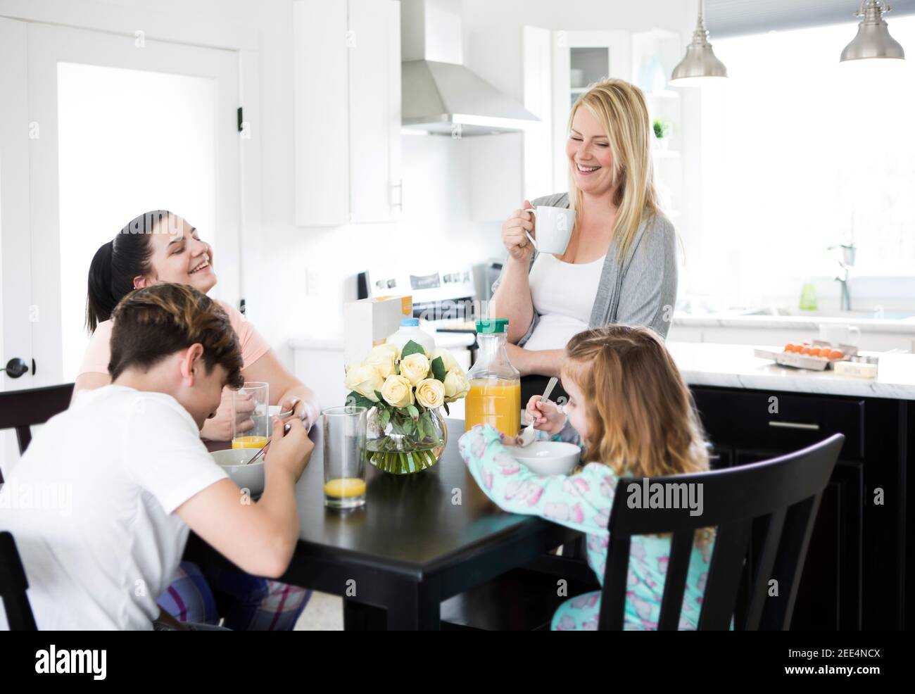 A family having a laugh around the breakfast table Stock Photo