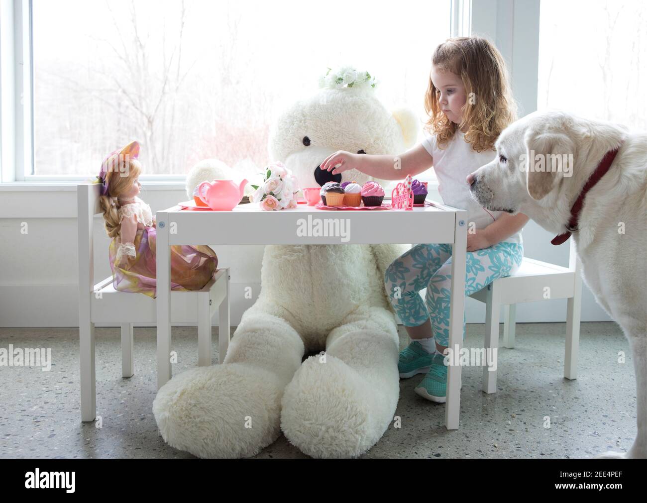 A little girl having a pretend tea party Stock Photo - Alamy