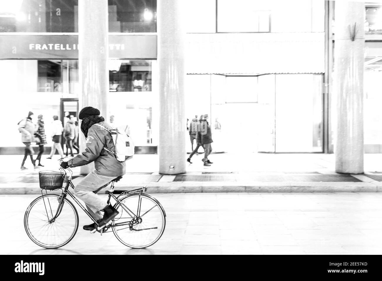 strangers walking and riding through the street Stock Photo