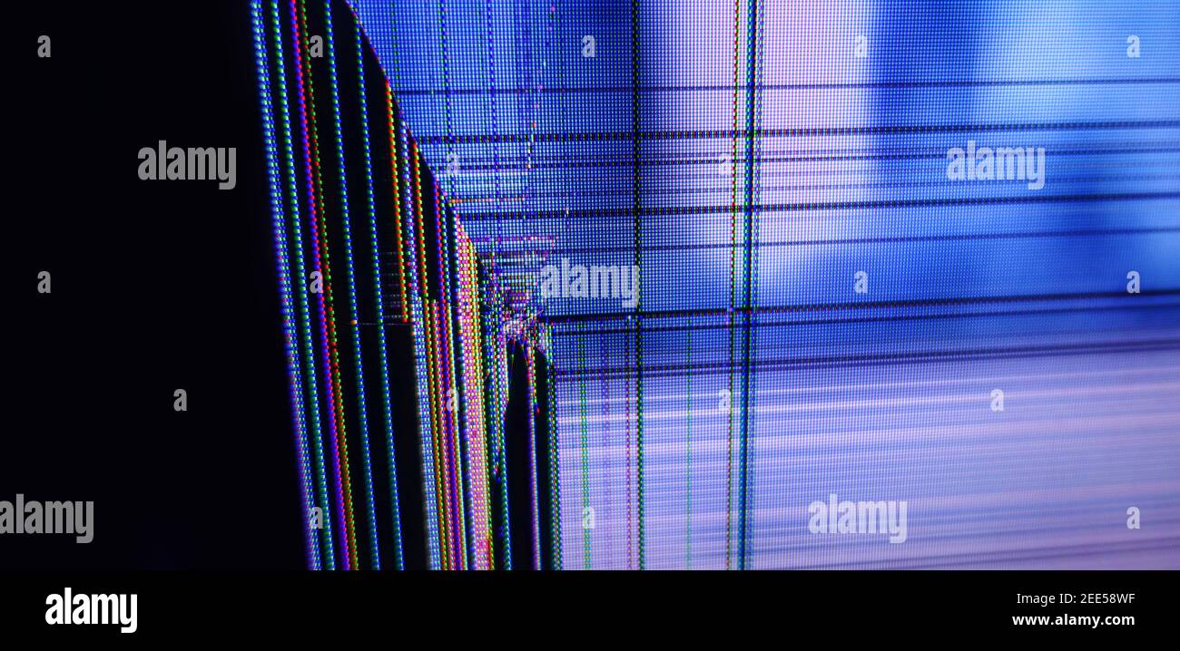Malfunctioning shattered computer monitor. Abstract technology background. Flickering bad LCD display. Glitch error from the broken screen. Stock Photo