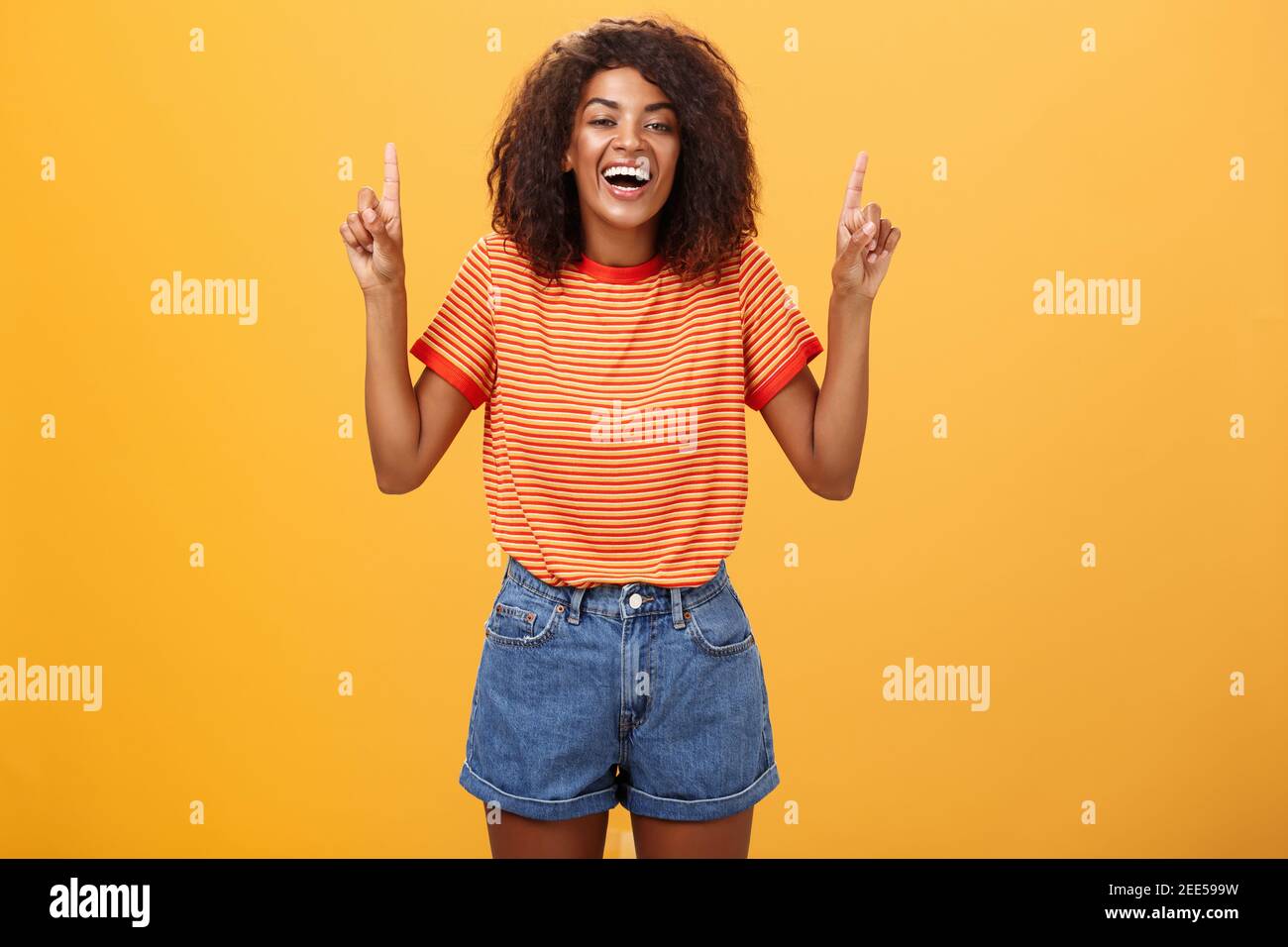 Woman feeling amused and entertained. Portrait of happy carefree stylish African-American girl with afro hairstyle laughing out loud joyfully pointing Stock Photo - Alamy Woman feeling amused and entertained. Portrait of happy carefree stylish African-American girl with afro hairstyle laughing out loud joyfully pointing Stock Photo - Alamy