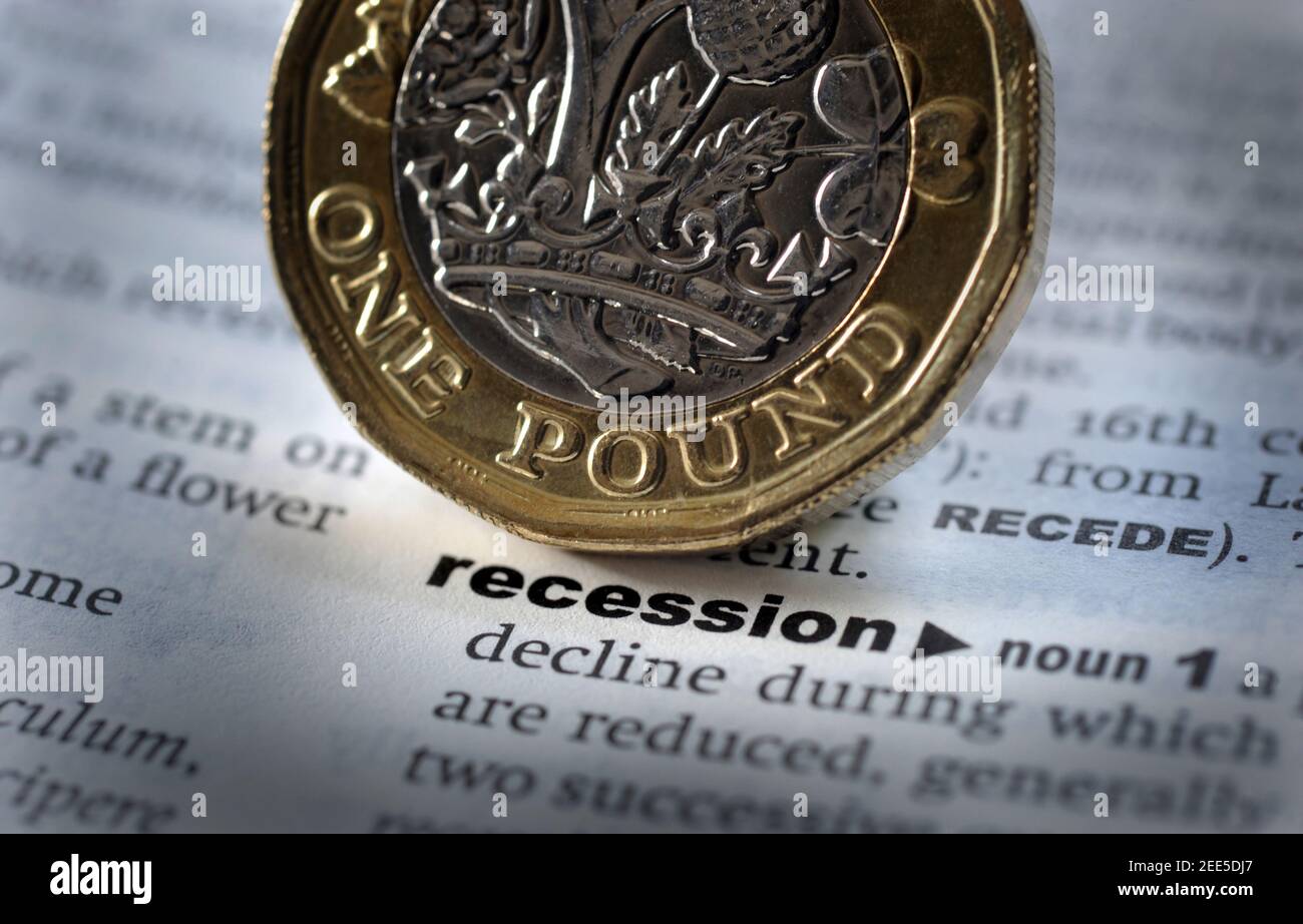 DICTIONARY DEFINITION OF RECESSION WITH ONE POUND COIN RE THE ECONOMY COVID 19 CORONAVIRUS JOBS FURLOUGH SCHEME THE HIGH STREET UNEMPLOYMENT ETC UK Stock Photo