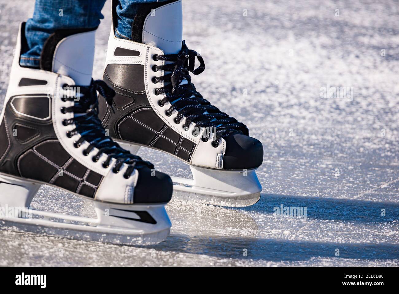 Detail of the black and white mens ice skates in action on ice Stock ...