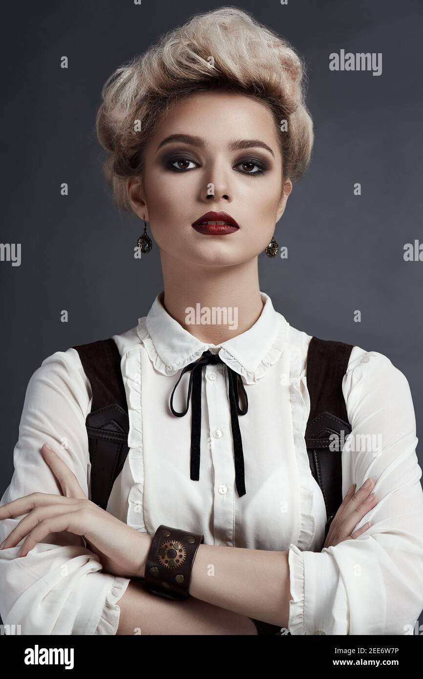 Beautiful blonde girl in steampunk style costume Stock Photo