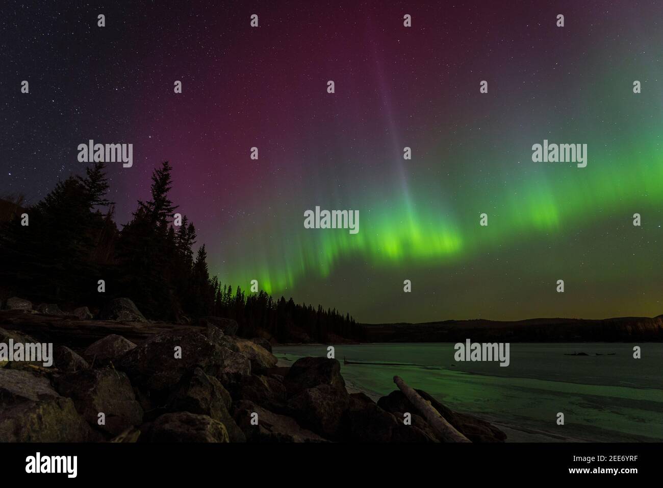 Aurora Borealis or Northern Lights from a lake during a winter night in Canada Stock Photo