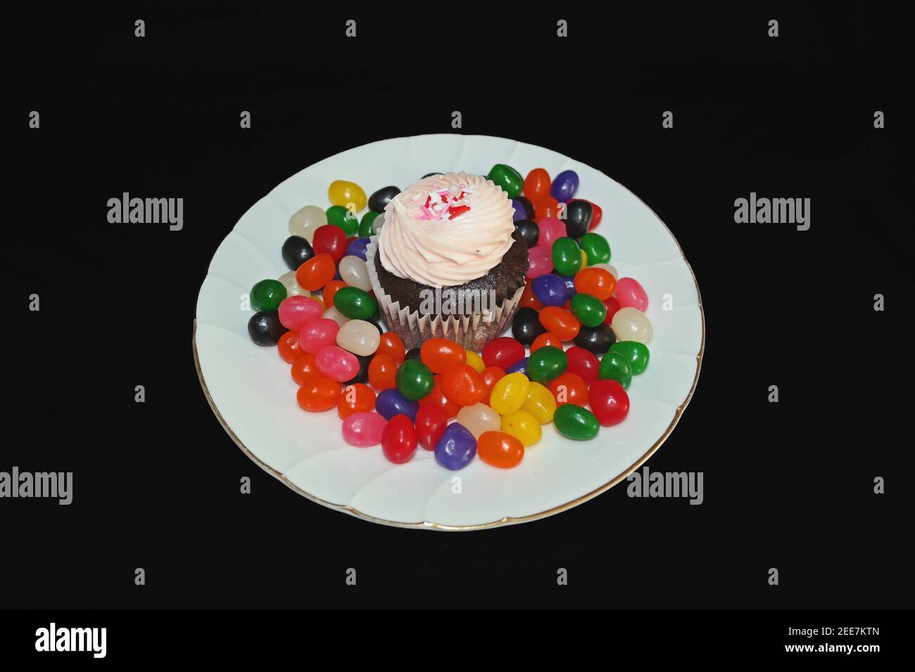 Strawberry Cupcake on Round White Plate with Candy Stock Photo