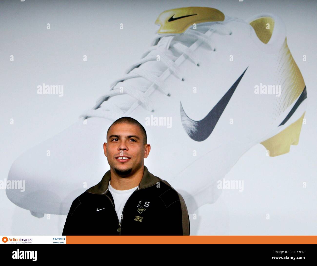 Action Images - Ronaldo - Nike - Launch of Mercurial Vapor III Boot -  Allianz Arena, Munich, Germany - 9/1/06 Real Madrid's Brazilian star  Ronaldo sits in front of a placard of