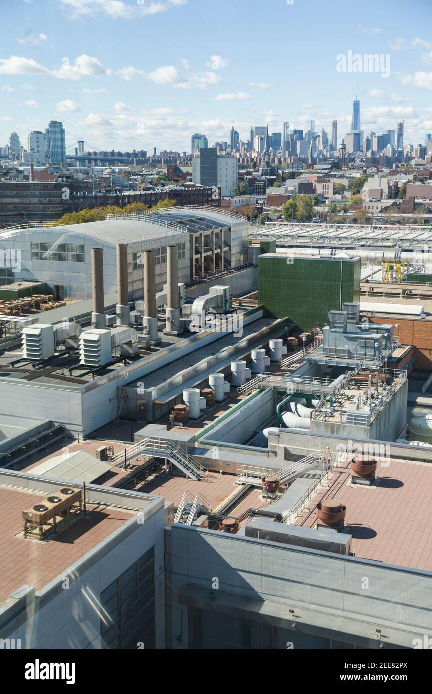 Architectural Photos of Greenpoint Waste Water Treatment Plant on a Sunny Day including the industrial area around the northern brooklyn and NYC Skyline Stock Photo