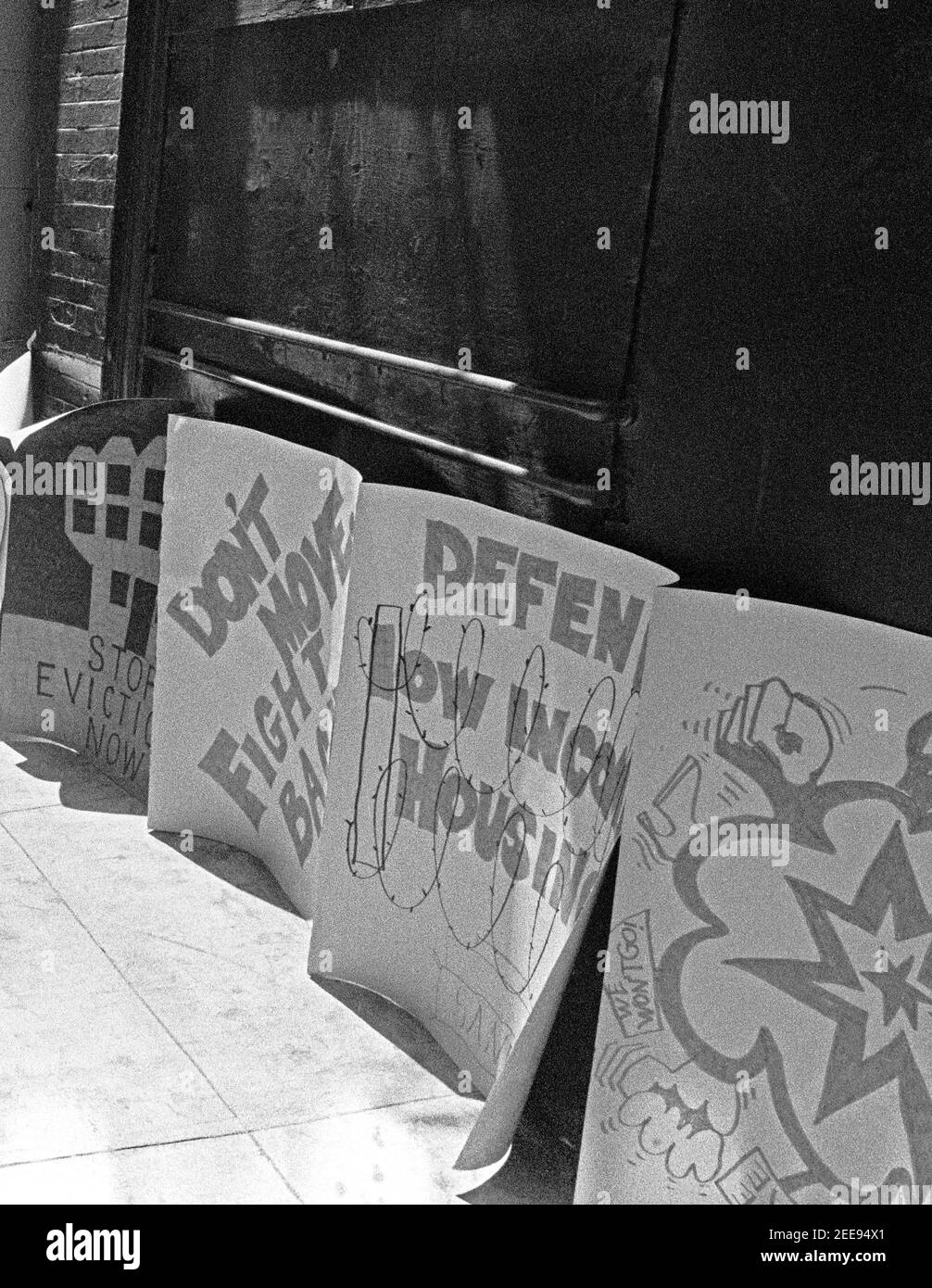 posters advocating for low income housing, on a San Francisco, California sidewalk in the 1980s Stock Photo