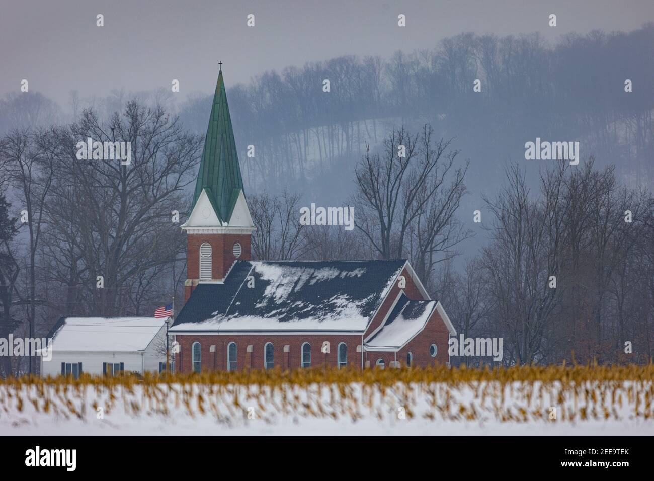 The Wegan Lutheran Church (Missouri Synod) in Jackson County, IN near sunset on a snow overcast afternoon. Stock Photo