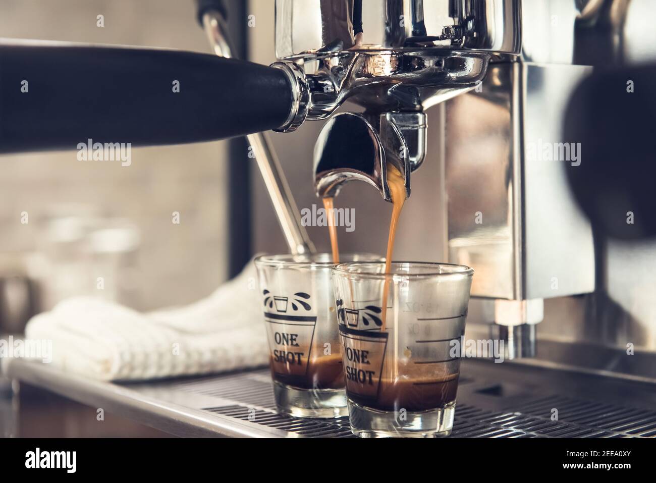 Close-up of espresso machine and shot glasses during a pour Stock