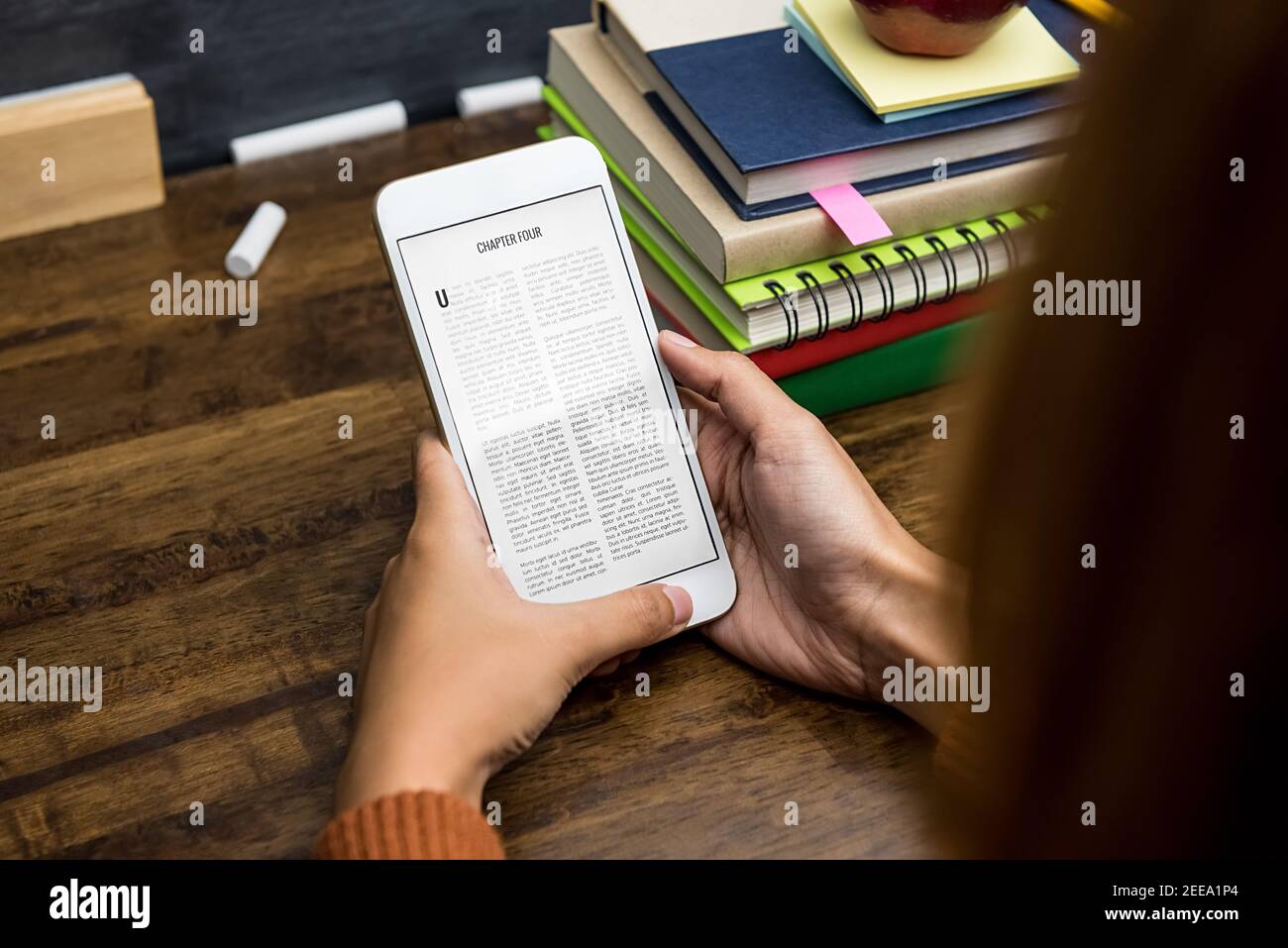 Student reading electronic book from portable digital tablet at the table Stock Photo