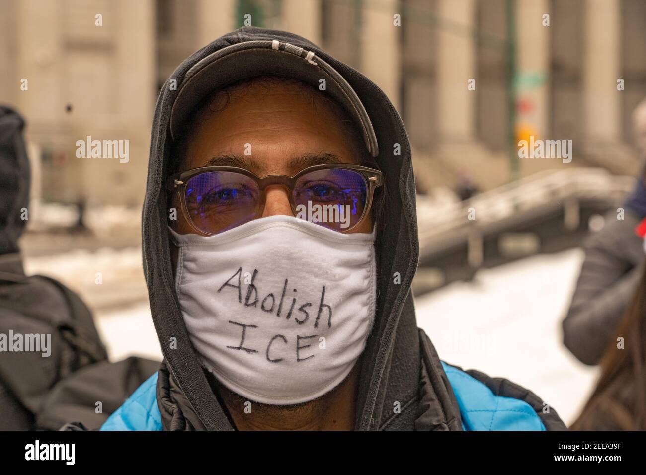 NEW YORK, NY - FEBRUARY 15: A protester ware an Abolish ICE face mask at Foley Square during an Abolish ICE (Immigration and Customs Enforcement) protest on February 15, 2021 in New York City.   Free Them All by Abolish ICE Coalition marched for Javier Castillo Maradiaga through downtown New York City. Mr. Maradiaga, a 27-year-old Bronx man who has lived in the U.S. since he was 7 years old was set to be deported by the U.S. Immigration and Customs Enforcement (ICE). Stock Photo