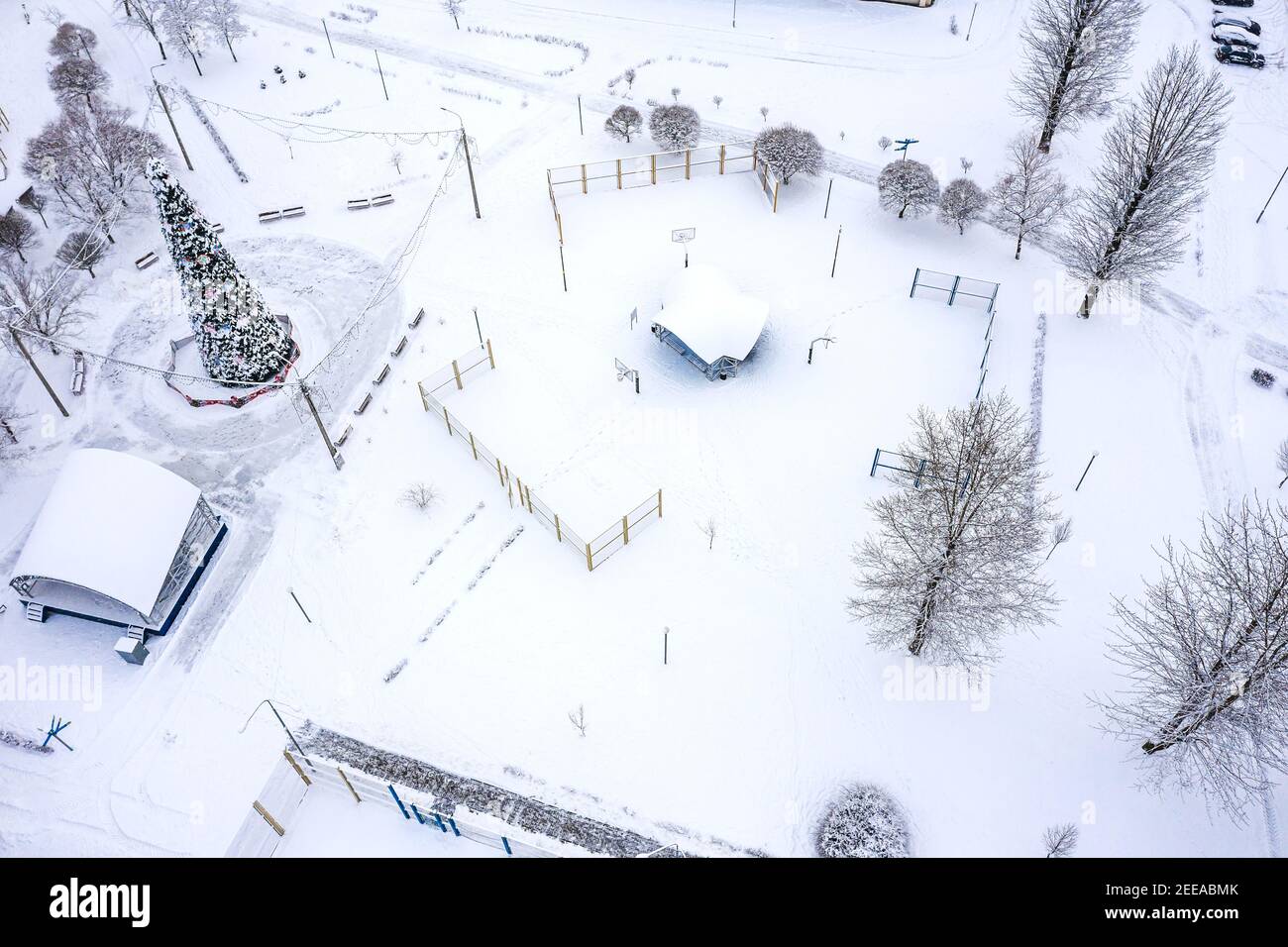empty sports ground for workout in a snowy park. quarantine during winter pandemic. aerial photo Stock Photo
