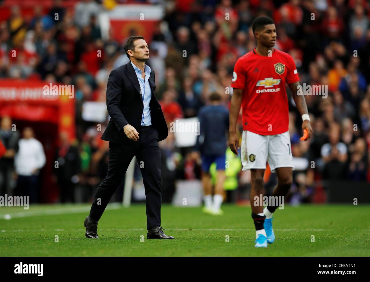 Soccer Football - Premier League - Manchester United v Chelsea - Old Trafford, Manchester, Britain - August 11, 2019  Chelsea manager Frank Lampard looks dejected at the end of the match while Manchester United's Marcus Rashford looks on  REUTERS/Phil Noble  EDITORIAL USE ONLY. No use with unauthorized audio, video, data, fixture lists, club/league logos or 'live' services. Online in-match use limited to 75 images, no video emulation. No use in betting, games or single club/league/player publications.  Please contact your account representative for further details. Stock Photo