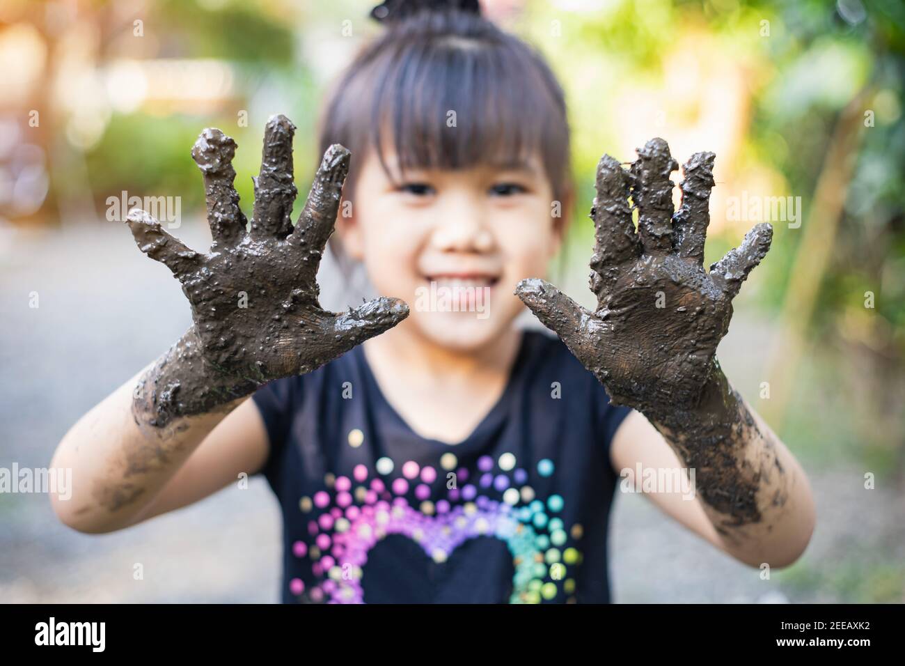 Kids playing with clay muddy. This activity is good for sensory experience and learning by touch their hands and fingers through clay Stock Photo