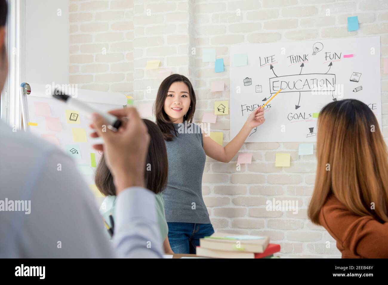 Oversea woman college student making a presentation in front of classroom Stock Photo