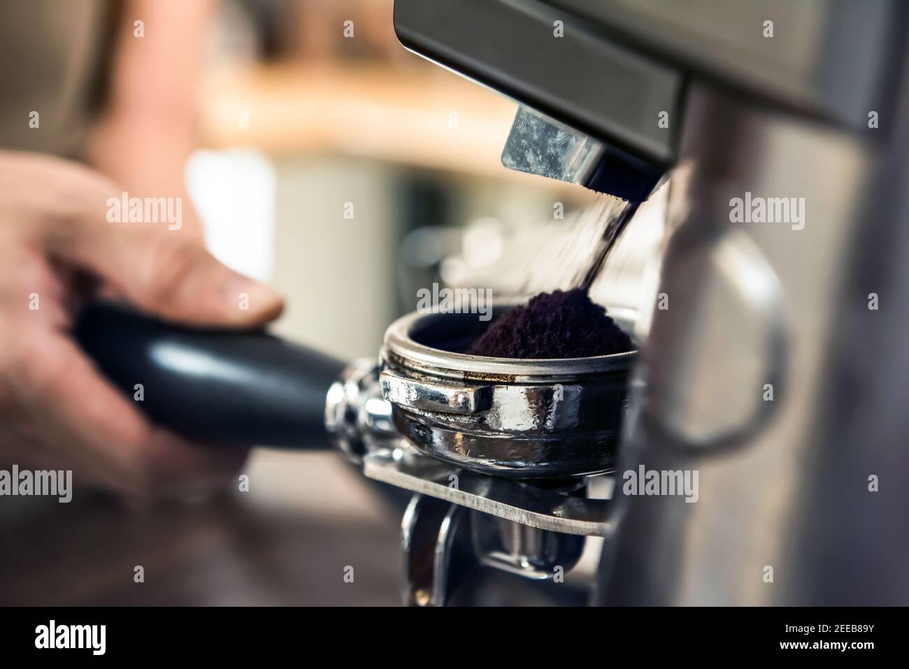 Automatic grinder machine grinding coffee beans into portafilter basket Stock Photo Alamy
