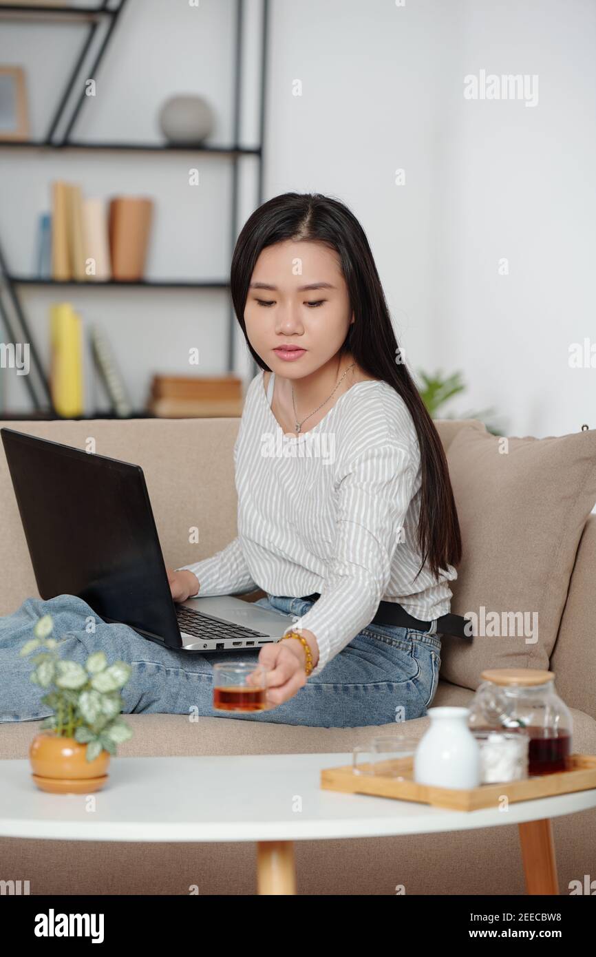 Young woman working on laptop Stock Photo
