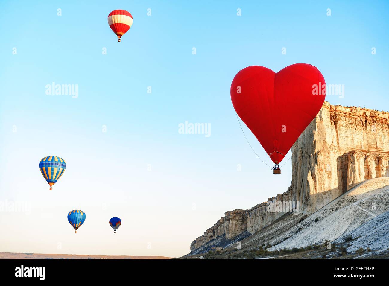Red heart-shaped air balloon flying in the sky Stock Photo - Alamy